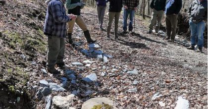 Group of woodlot program participants gathered in the forest on an early spring day