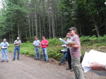 Wisconsin DNR forestry staff leading a field tour at Caroline Lake SNA. 