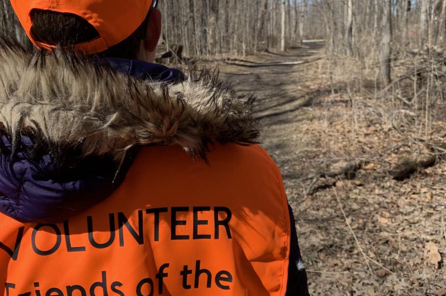 Volunteer with Columbus County Park in orange vest